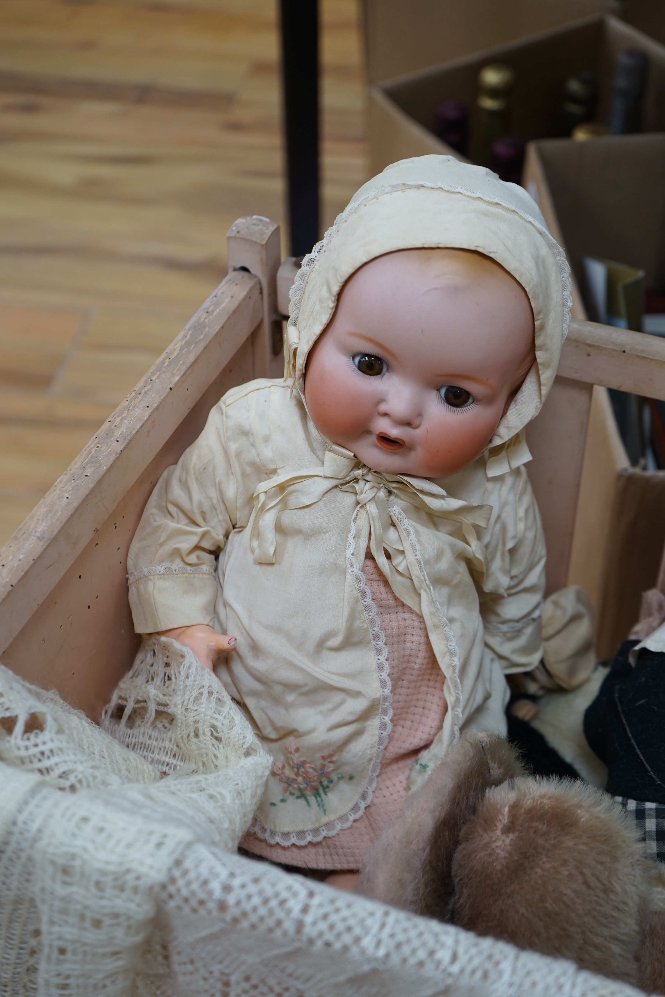 An Armand Marseille bisque head baby doll, a black plastic doll and other dolls and toys
